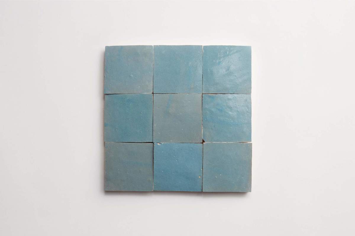 Nine square blue tiles arranged in a three-by-three grid on a white background.