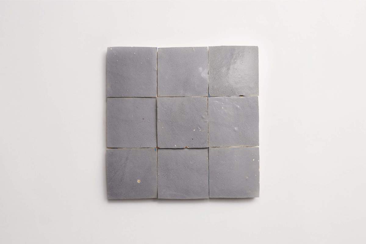 Nine square gray tiles are arranged in a 3x3 grid on a plain white background.