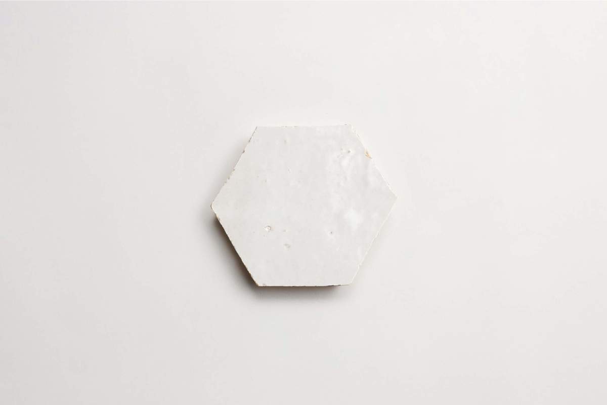 A white hexagonal tile is centered on a plain white background.