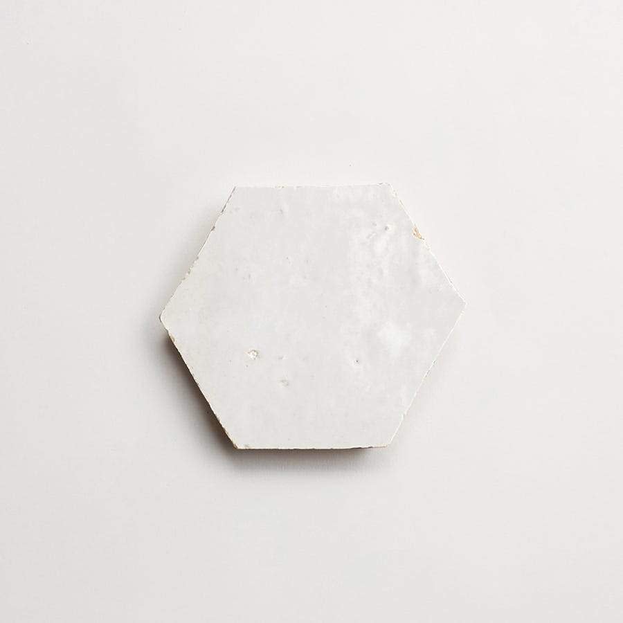 A white hexagonal tile on a plain light background.