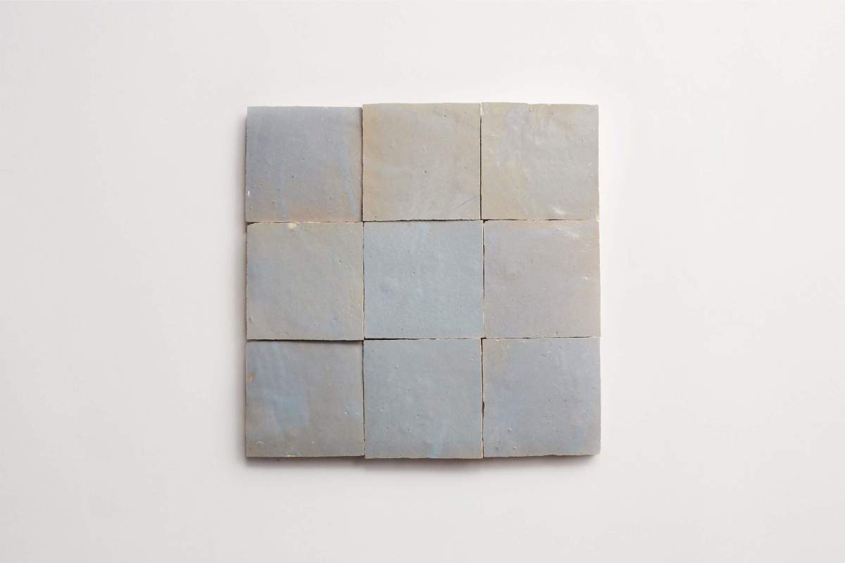 Nine pale gray square tiles are arranged in a 3x3 grid on a white background.