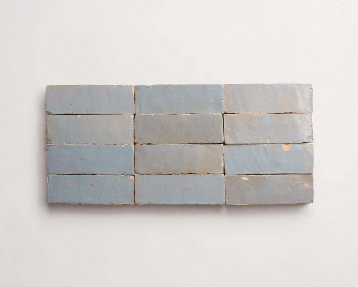 Ten rectangular, light blue-gray bricks are arranged in two rows of five on a plain white background.