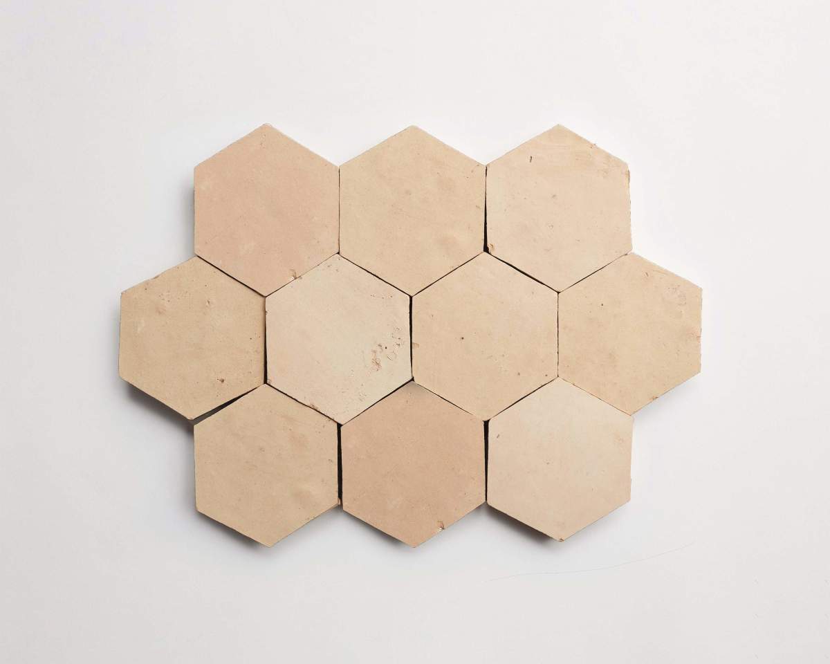 Eight beige hexagonal tiles are arranged in a honeycomb pattern on a plain white background.