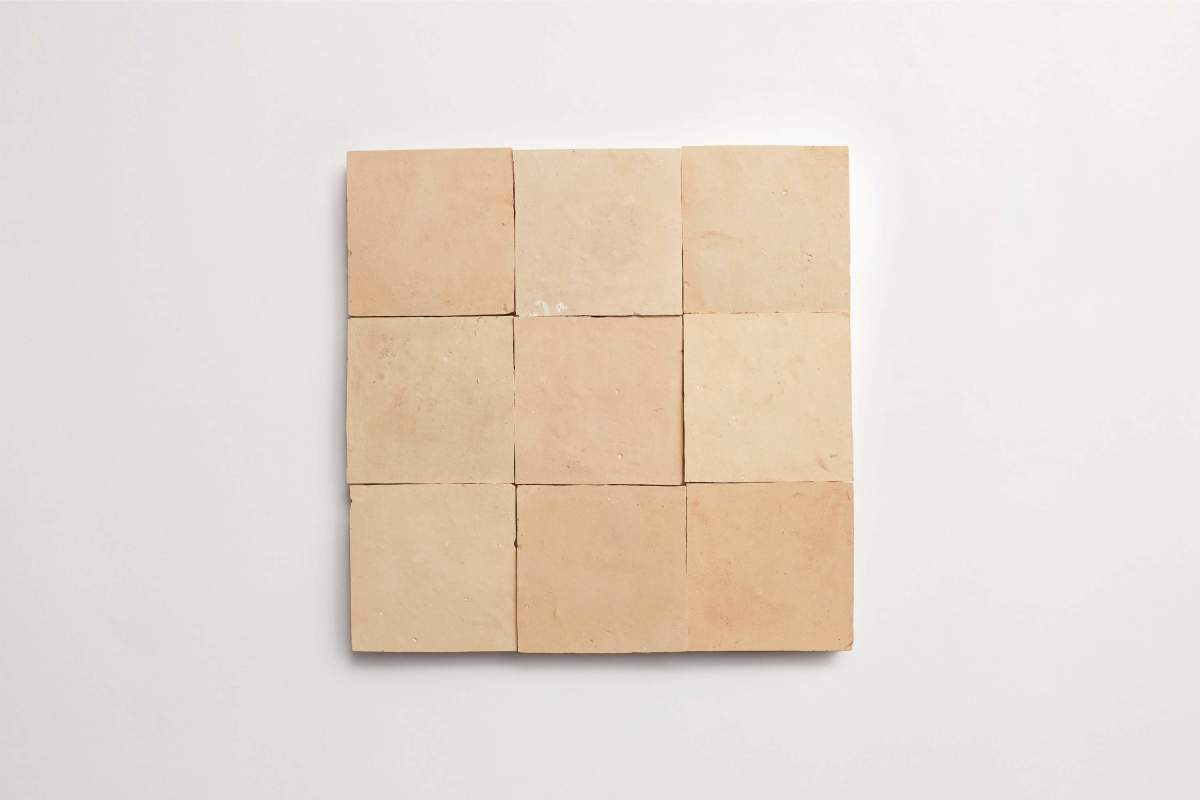 Nine beige square tiles arranged in a three-by-three grid on a plain white background.