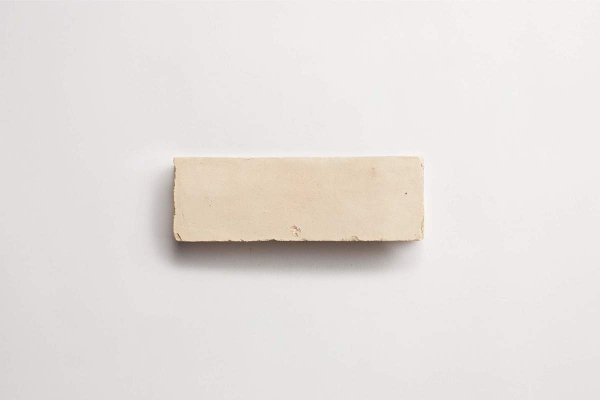 A single rectangular beige brick is placed on a plain white background.