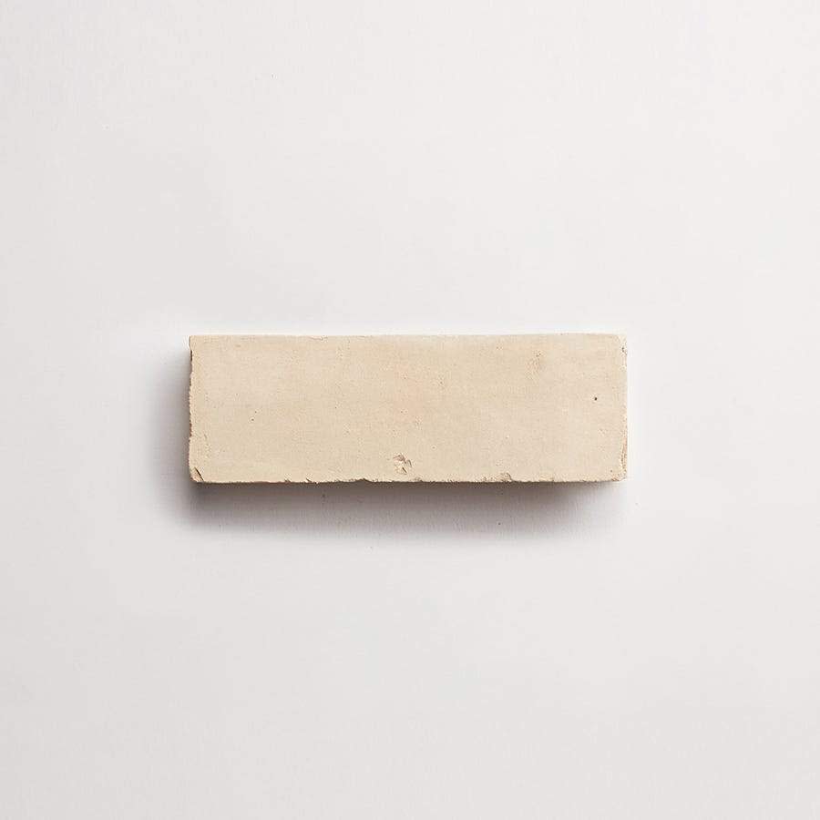 A rectangular, off-white brick is centered on a plain white background.