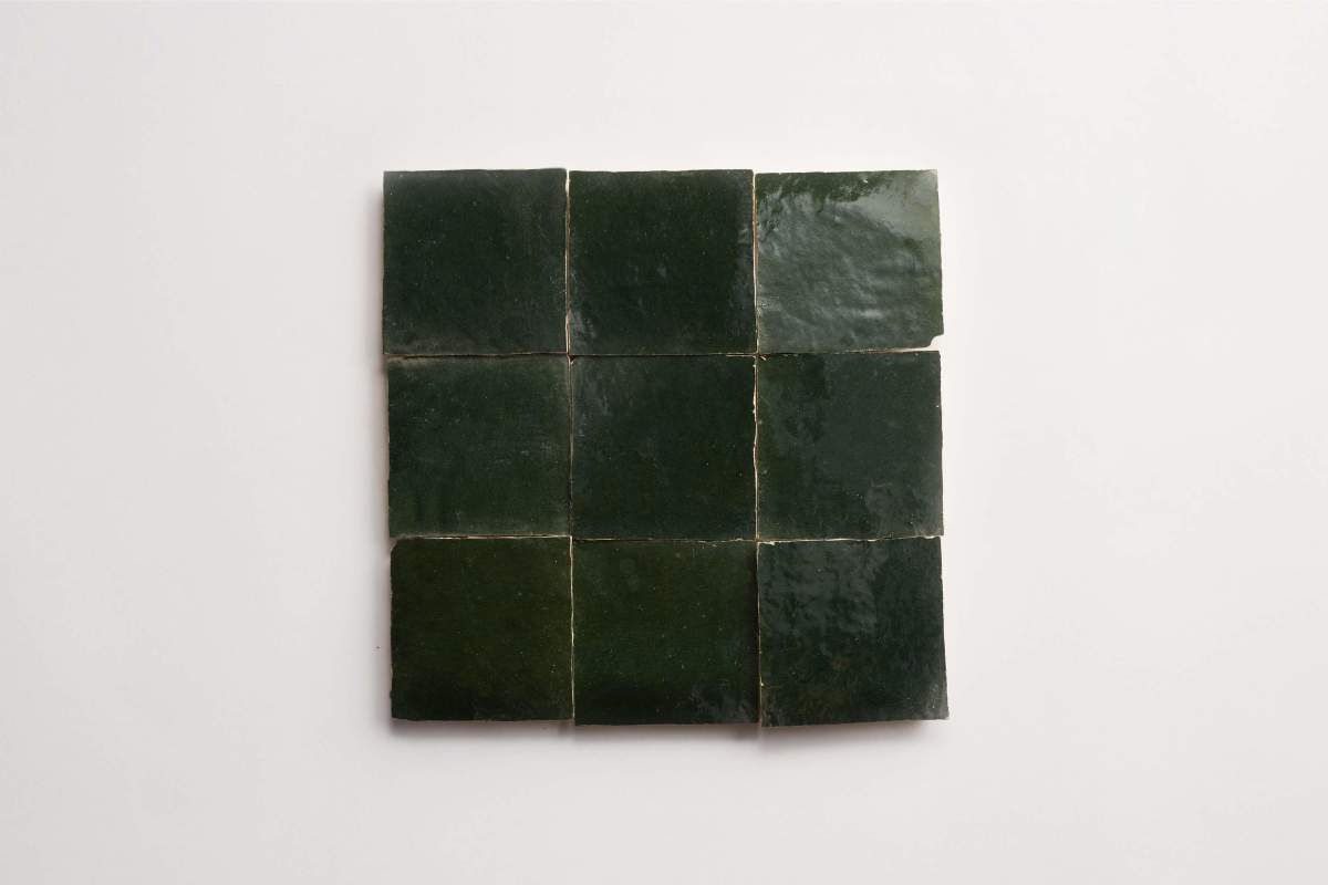 Nine dark green square tiles arranged in a 3x3 grid on a white background.