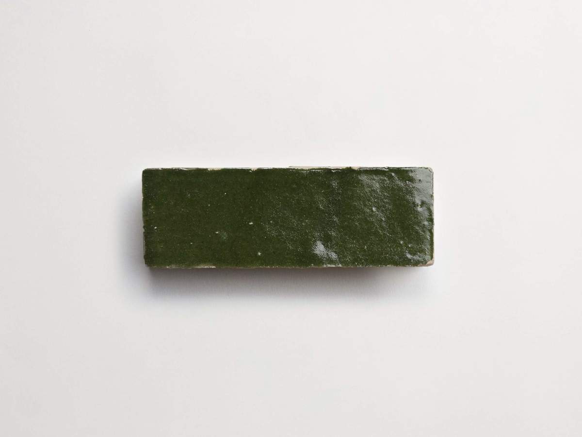 A single rectangular green tile with a glossy surface, placed on a plain white background.