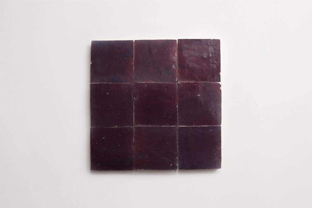 Nine dark purple square tiles arranged in a 3-by-3 grid on a plain white background.