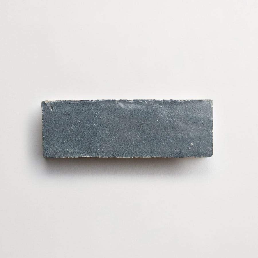 A single rectangular gray brick placed on a plain white background.