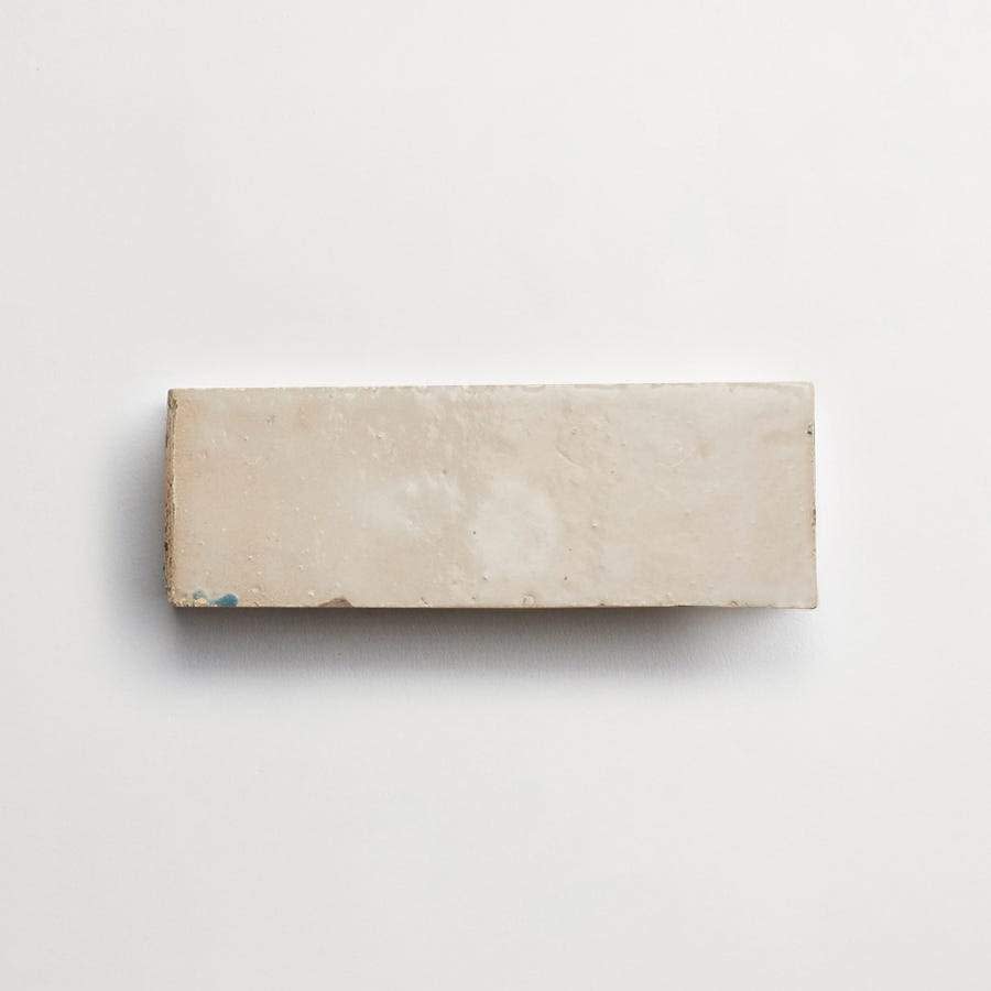 A rectangular, off-white ceramic tile is shown against a plain white background.