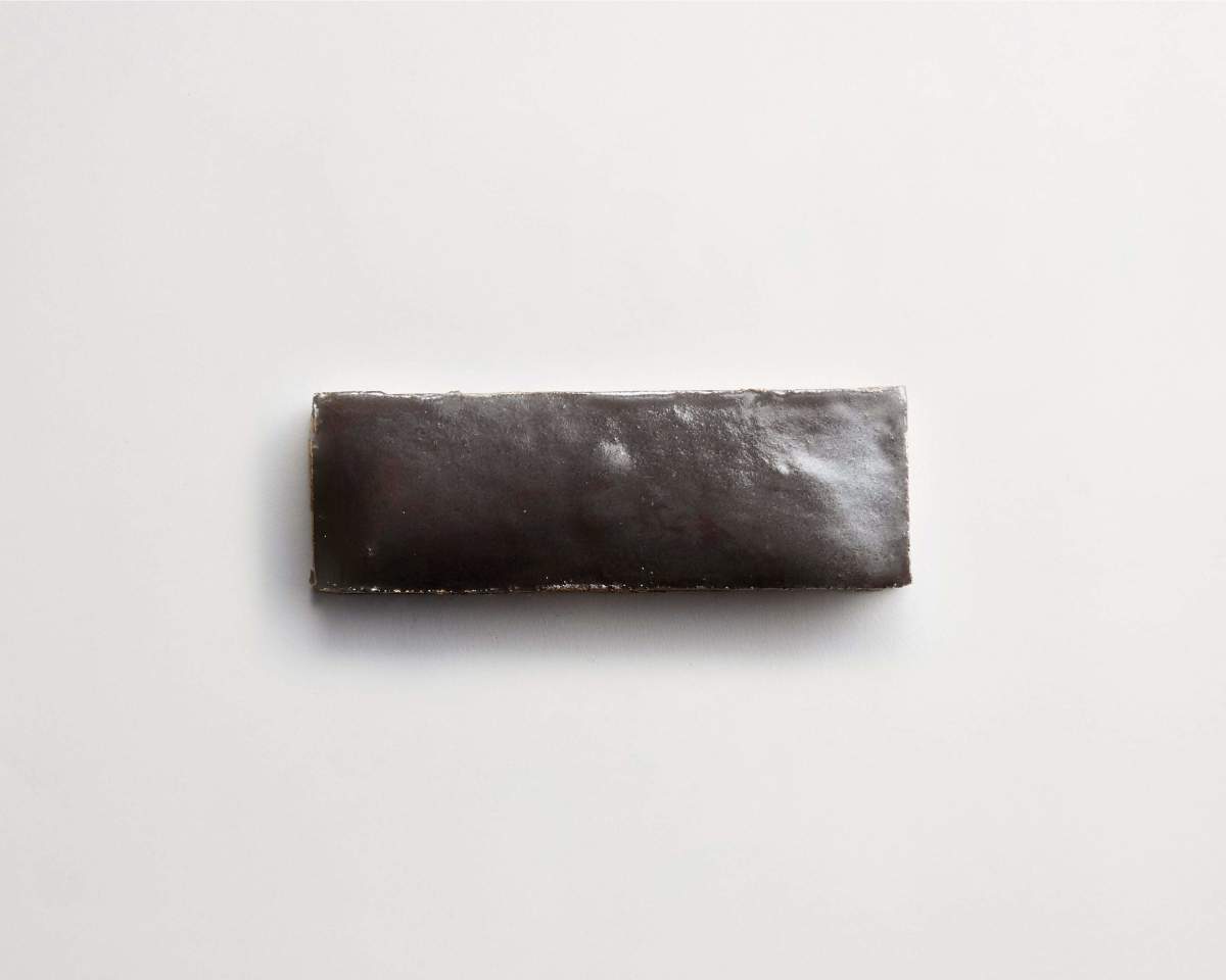 A single rectangular black licorice candy bar on a plain white background.