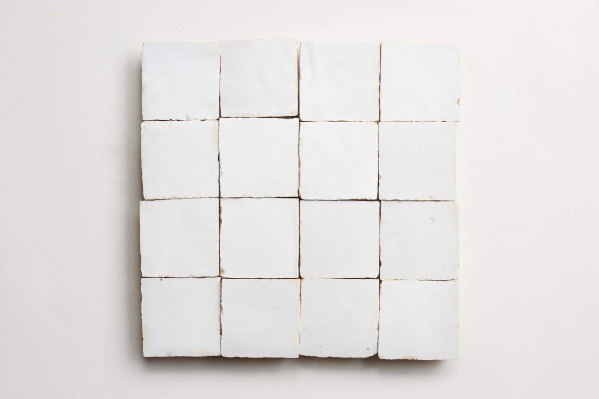 A grid of sixteen white square tiles arranged in four rows and four columns on a plain background.
