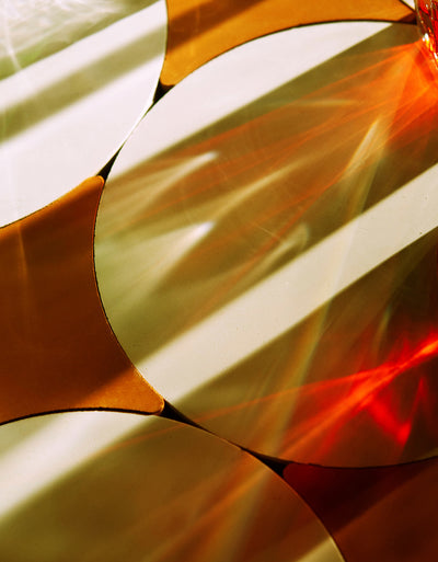 Close-up of a colorful fabric with circular patterns in orange, red, and white