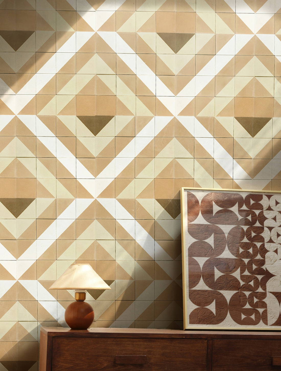 Patterned wall tiles with a wooden sideboard and lamp in a room setting

