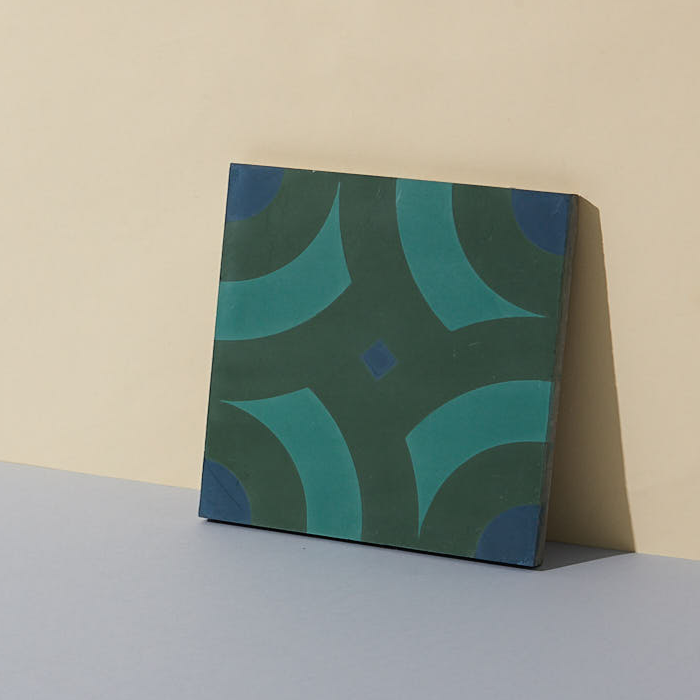 A single green and blue patterned square cement tile