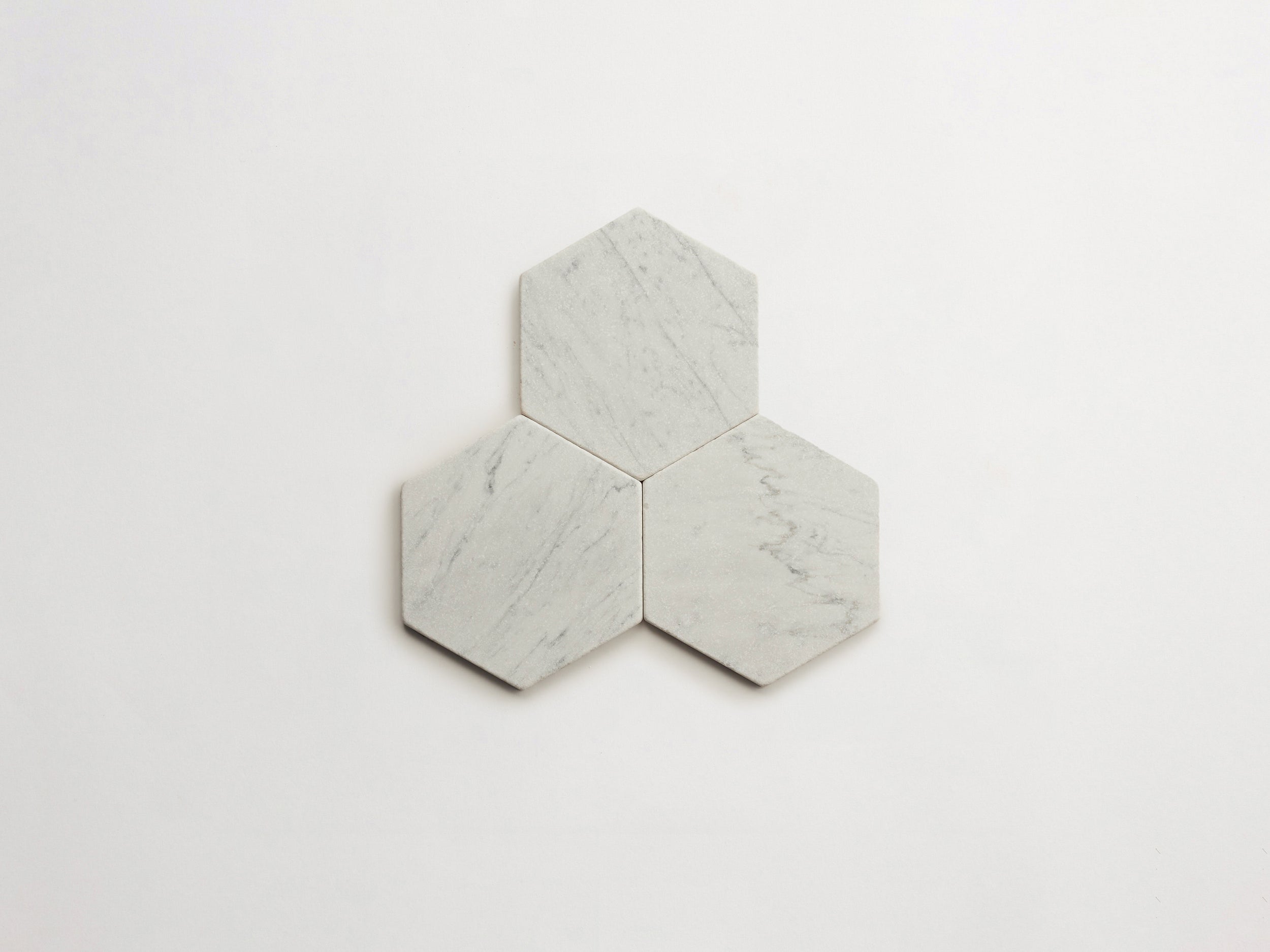 cle-tile-stone-tumbled-lapidary-carrara-hex-3up-3000x2250-300dpi .jpg